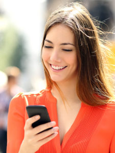 Woman checking chat on smartphone